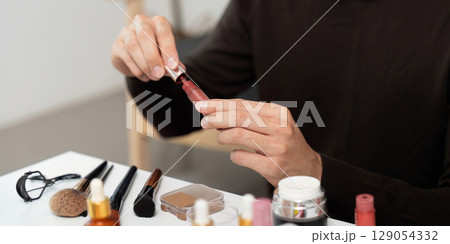Makeup Application: Man Preparing Lip Color at Vanity 129054332