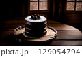 Decadent Chocolate Cake with Powdered Sugar and Chocolate Truffles on a Rustic Wooden Platter 129054794