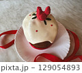 Festive dessert featuring decorative chicken atop a cake at a celebration event 129054893