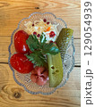 Fresh and colorful pickled vegetables served in a glass dish 129054939