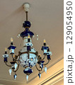 Elegant antique chandelier with blue accents in a vintage interior 129054950