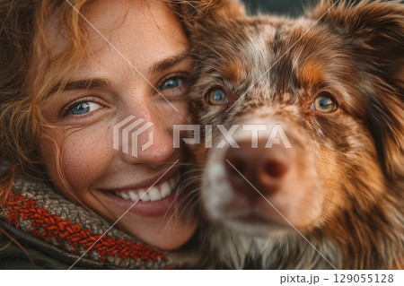 Close-up portrait of an Australian Shepherd dog with striking blue eyes and a textured coat 129055128