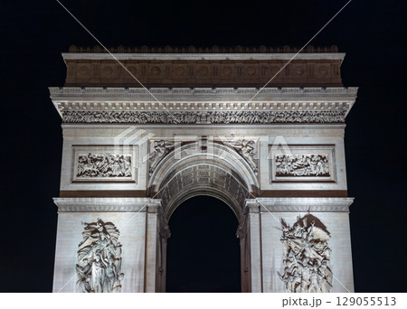 Stunning details night view of Famous Arc de Triomphe or Triumphal Arch in Paris. Stunning details night view of Famous Arc de Triomphe or Triumphal Arch in Paris. 129055513