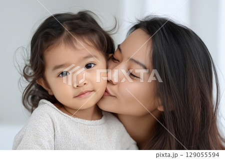 A serene and heartwarming moment showcasing a close-up of a mother embracing her child 129055594