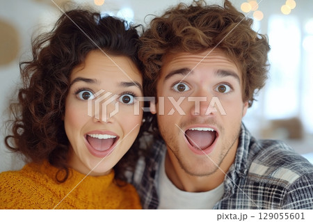 A cozy indoor scene highlighting the beauty of natural curls and casual fashion. 129055601