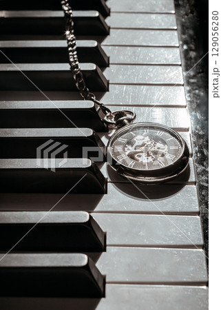 Perspective of Antique pocket watch or Retro pocket watch on Piano keys background. 129056280