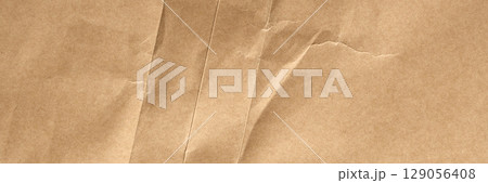 Crumpled old brown wrapping paper with aged folds and rough wrinkles.  Abstract background 129056408