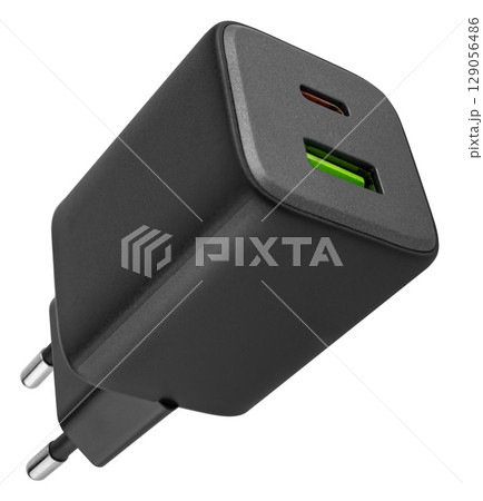 Classic white power adapter with USB port. on white background in insulation 129056486