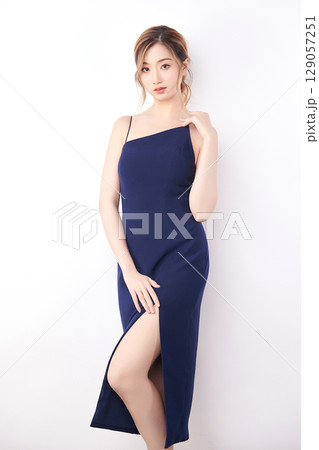 Beautiful face of young Asian woman in sexy dress Blue Perfect slim body on white background, plastic surgery and aesthetic cosmetology, Facial and skin care concept 129057251