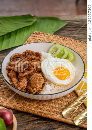 The Stir fried garlic pepper pork and fried egg image for Thai food concept. The Stir fried garlic pepper pork and fried egg image for Thai food concept. 129057306
