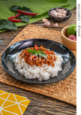 The Stir Fried Pork and Yard Long Bean with Curry Paste image for Thai food concept. The Stir Fried Pork and Yard Long Bean with Curry Paste image for Thai food concept. 129057308