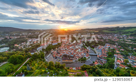 At dawn, Cesky Krumlov awakens beneath a vibrant sky. The UNESCO-listed town showcases its medieval architecture, winding river, and the imposing castle, creating a picturesque view. At dawn, Cesky Krumlov awakens beneath a vibrant sky. The UNESCO-listed town showcases its medieval architecture, winding river, and the imposing castle, creating a picturesque view. 129058067