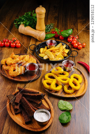 Delightful assortment of appetizers with sauces on a wooden table 129058112