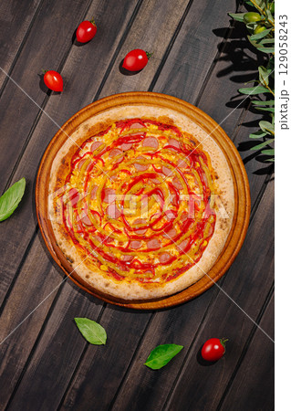 Delicious freshly baked pizza with toppings on a wooden table 129058243