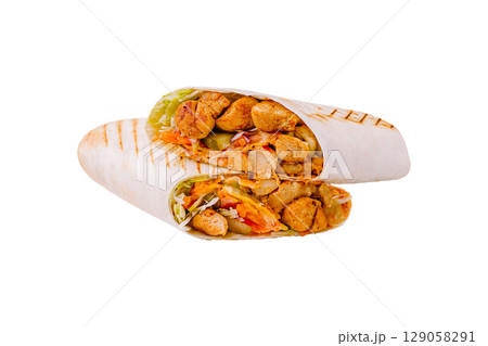 Delicious grilled chicken wraps filled with fresh vegetables and sauce 129058291
