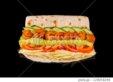 Delicious shrimp sandwich with fresh vegetables and sauces on a flatbread Delicious shrimp sandwich with fresh vegetables and sauces on a flatbread 129058299