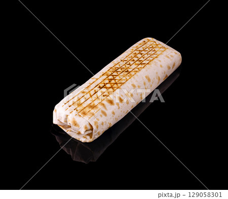 Delicious grilled wrap with distinctive marks on a dark background Delicious grilled wrap with distinctive marks on a dark background 129058301