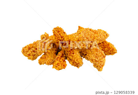 Crispy fried chicken tenders piled high on a white background 129058339