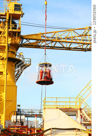 Crews boat moving the passenger and cargo from the platform to supply boat in oil and gas industry. Support offshore oil and gas industry by boat and service team. Crews boat moving the passenger and cargo from the platform to supply boat in oil and gas industry. Support offshore oil and gas industry by boat and service team. 129058360
