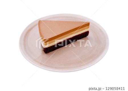 Delicious layered dessert with chocolate and cream on a white plate Delicious layered dessert with chocolate and cream on a white plate 129058411