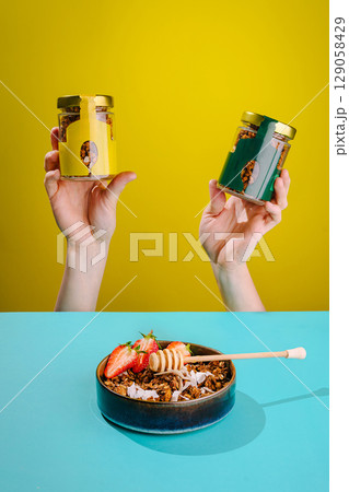 Healthy snacks displayed in colorful jars with fruit and honey on table Healthy snacks displayed in colorful jars with fruit and honey on table 129058429