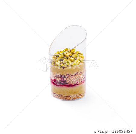 Delicious layered dessert with pistachios showcased on a clean surface Delicious layered dessert with pistachios showcased on a clean surface 129058457