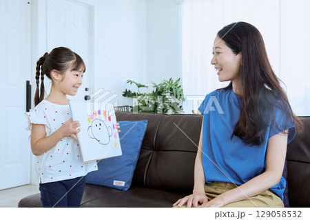 子どもが描いた絵を母親に見せる微笑ましい親 129058532