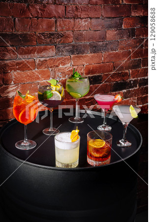 Colorful cocktails arranged elegantly on a black table in a stylish bar 129058688