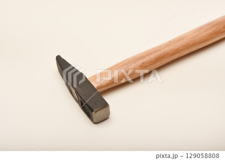 A small hammer with a wooden handle. A hammer on a white background. 129058808