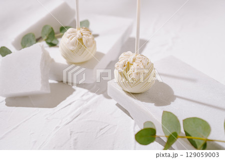 Unique dessert creation showcasing elegant white sweets on minimalistic display Unique dessert creation showcasing elegant white sweets on minimalistic display 129059003
