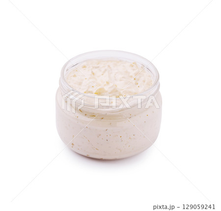 Creamy natural skincare lotion in a glass jar with herbal essence Creamy natural skincare lotion in a glass jar with herbal essence 129059241