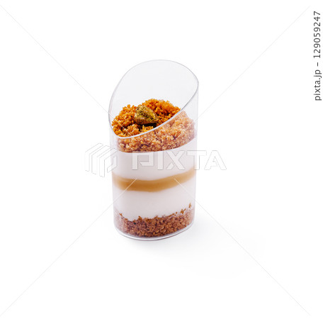 Delightful dessert with layers of yogurt, caramel, and cookie crumble Delightful dessert with layers of yogurt, caramel, and cookie crumble 129059247
