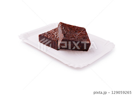 Deliciously rich chocolate brownies on a white plate Deliciously rich chocolate brownies on a white plate 129059265
