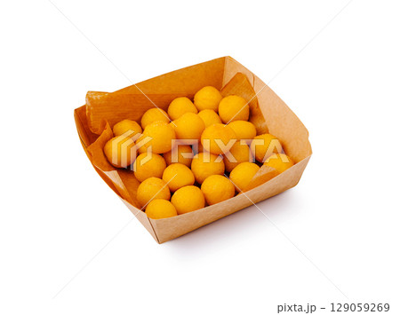 Delicious golden snacks served in a rustic paper tray at a festive gathering Delicious golden snacks served in a rustic paper tray at a festive gathering 129059269