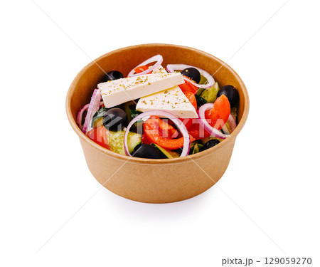 Fresh salad bowl with vegetables and feta cheese served in a container 129059270