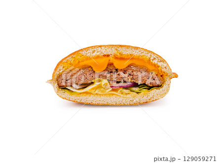Juicy burger with melted cheese and fresh vegetables in a bread roll 129059271