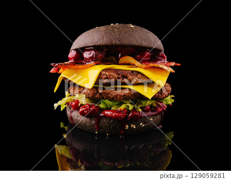 Unique gourmet burger stacked with bacon, cheese, and special sauce 129059281