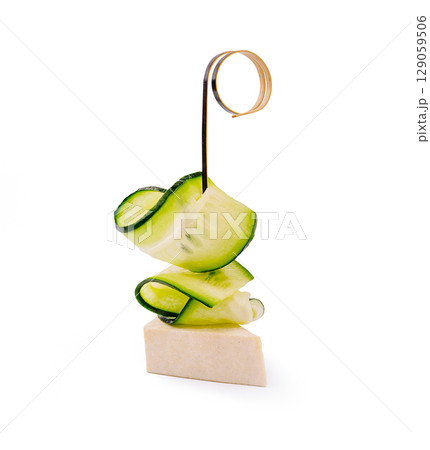 Creative cucumber sculpture on a simple base showcasing culinary art 129059506
