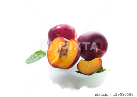 Ripe juicy nectarines isolated on white background Ripe juicy nectarines isolated on white background 129059589