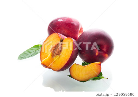 Ripe juicy nectarines isolated on white background Ripe juicy nectarines isolated on white background 129059590