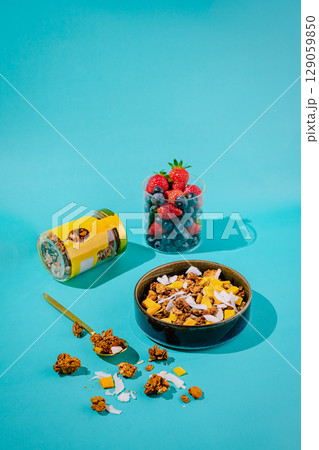 Colorful granola bowl with fresh fruit and vibrant background decor Colorful granola bowl with fresh fruit and vibrant background decor 129059850