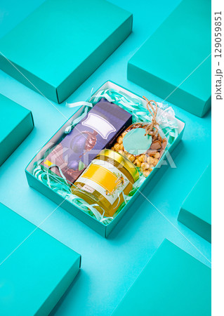 Beautiful gift box filled with treats arranged on a colorful background Beautiful gift box filled with treats arranged on a colorful background 129059851