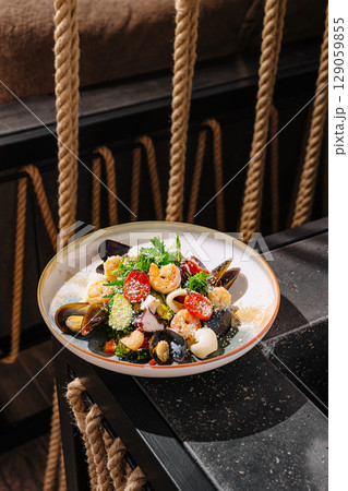Fresh seafood dish served on a rustic dining table in a cozy restaurant 129059855