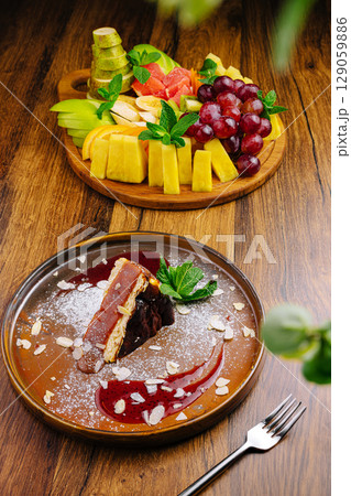 Delicious dessert plate with fresh fruit display in a cozy restaurant setting 129059886