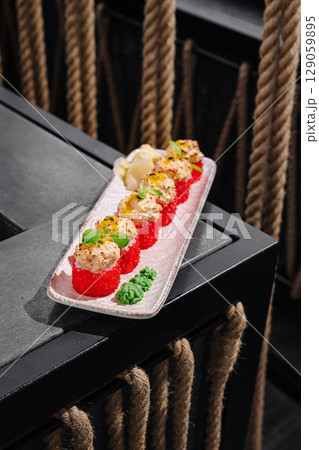 Sushi platter with vibrant colors served on a modern black table setup Sushi platter with vibrant colors served on a modern black table setup 129059895