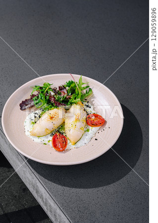 Fresh seafood dish served on a minimalistic plate at a modern restaurant Fresh seafood dish served on a minimalistic plate at a modern restaurant 129059896