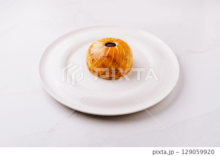 Delicious spherical dessert presented on a white plate for elegant dining 129059920