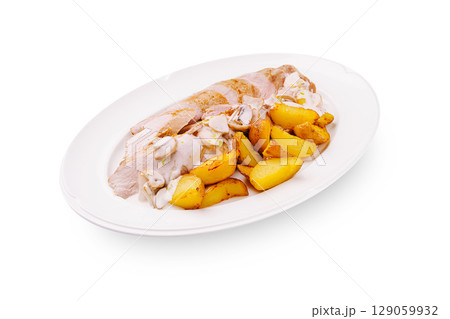 Sliced chicken with roasted potatoes and creamy sauce served on a plate Sliced chicken with roasted potatoes and creamy sauce served on a plate 129059932