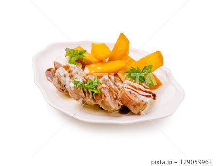 Savory grilled chicken skewers served with fresh mango slices and herbs Savory grilled chicken skewers served with fresh mango slices and herbs 129059961