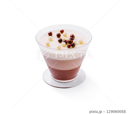 Chocolate and cream dessert in layered glass cup with toppings Chocolate and cream dessert in layered glass cup with toppings 129060088